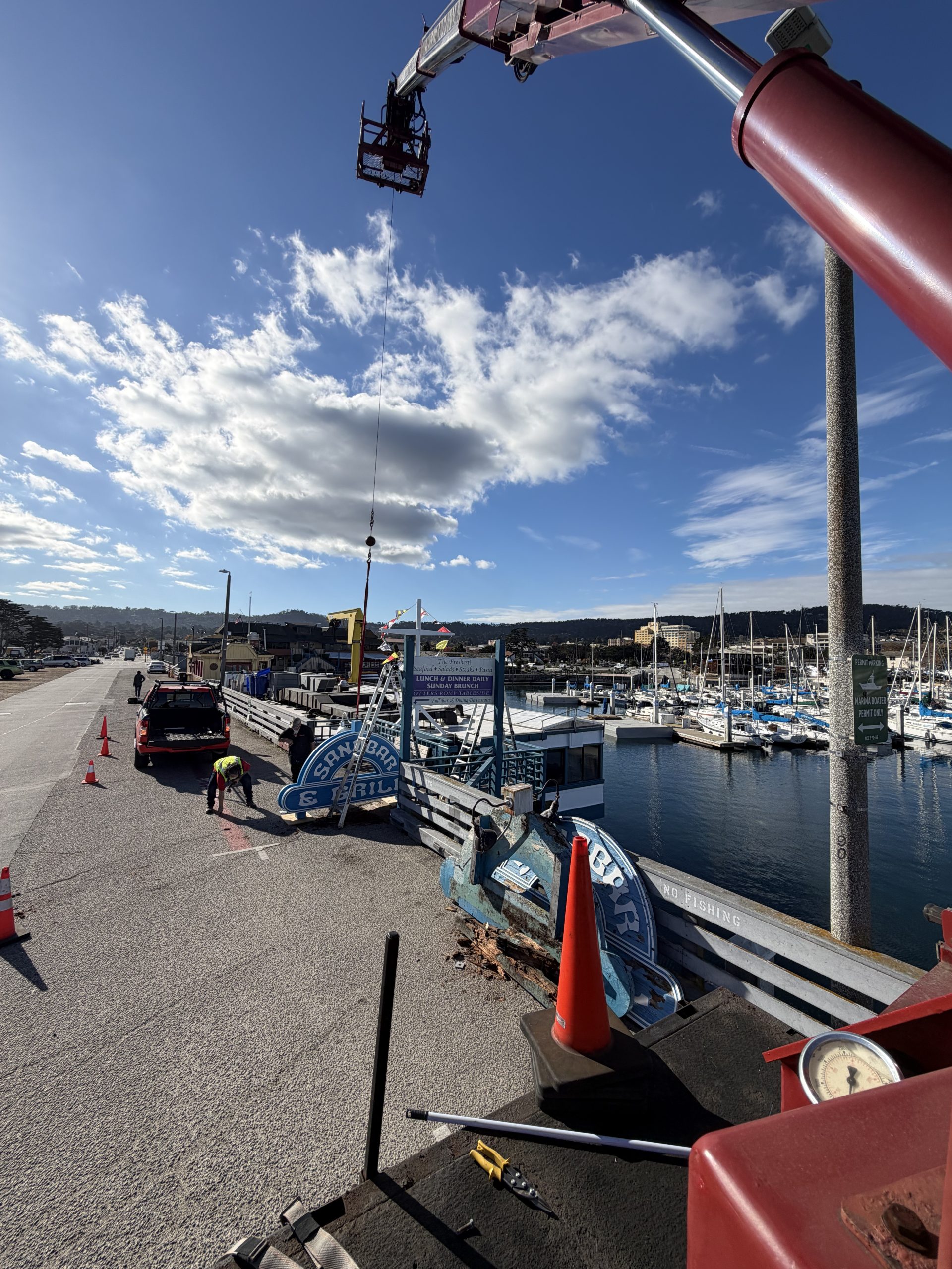 View from Signworks Elliott L60 boom truck during sign installation on Municipal Wharf 2 Monterey