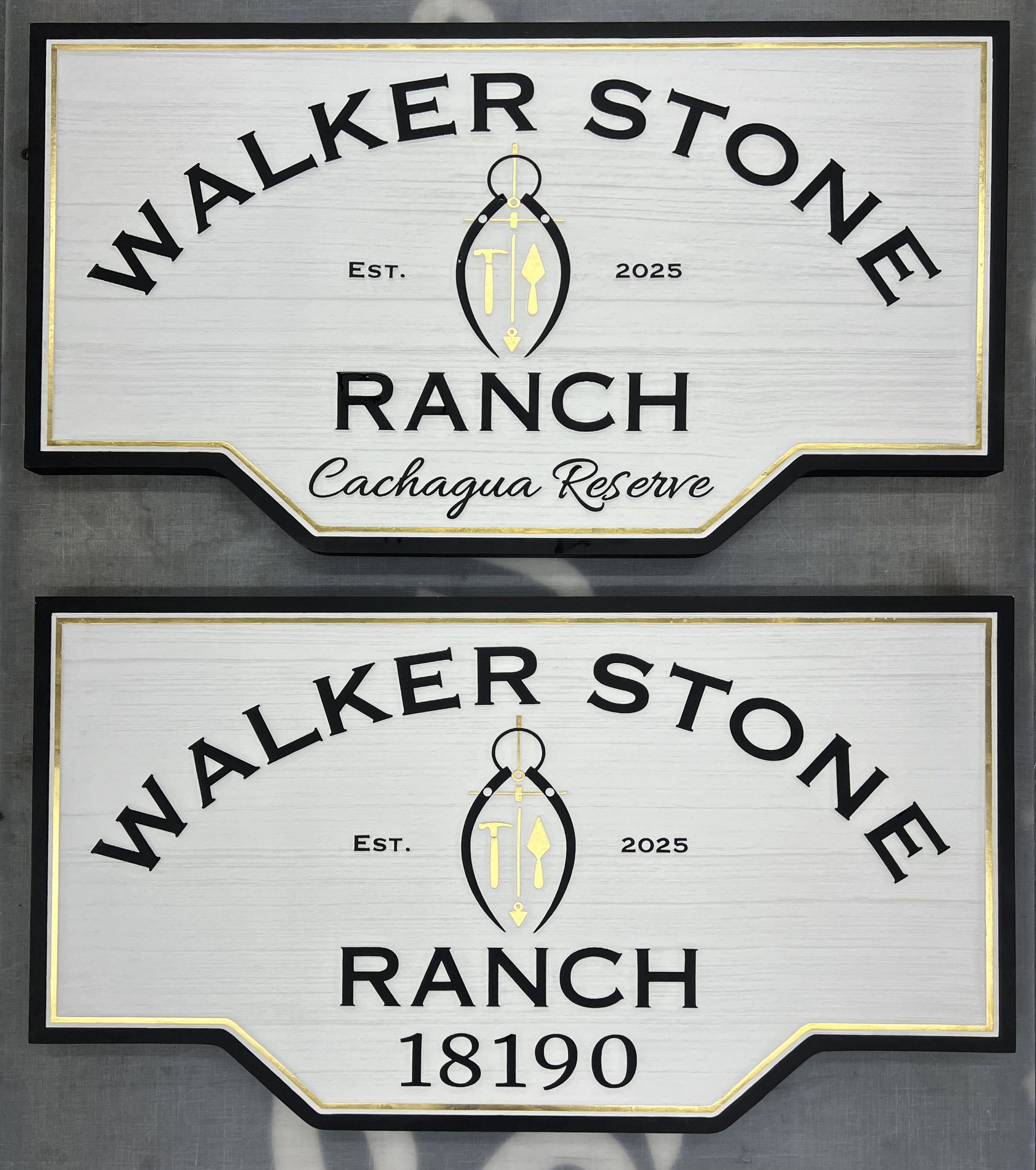 Two finished sandblasted cedar signs with hand-painted lettering and gold leaf accents by Signworks