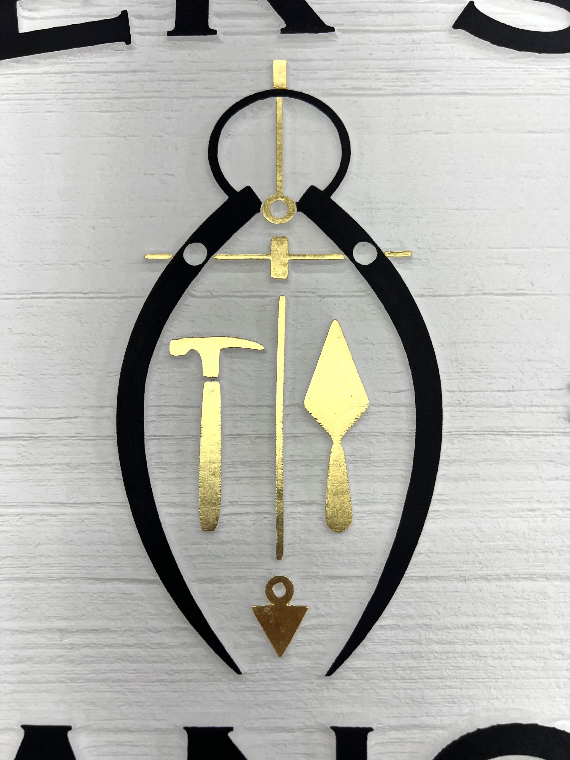 Close-up of 23-karat gold leaf applied to a sandblasted wood sign by Signworks on the Monterey Peninsula