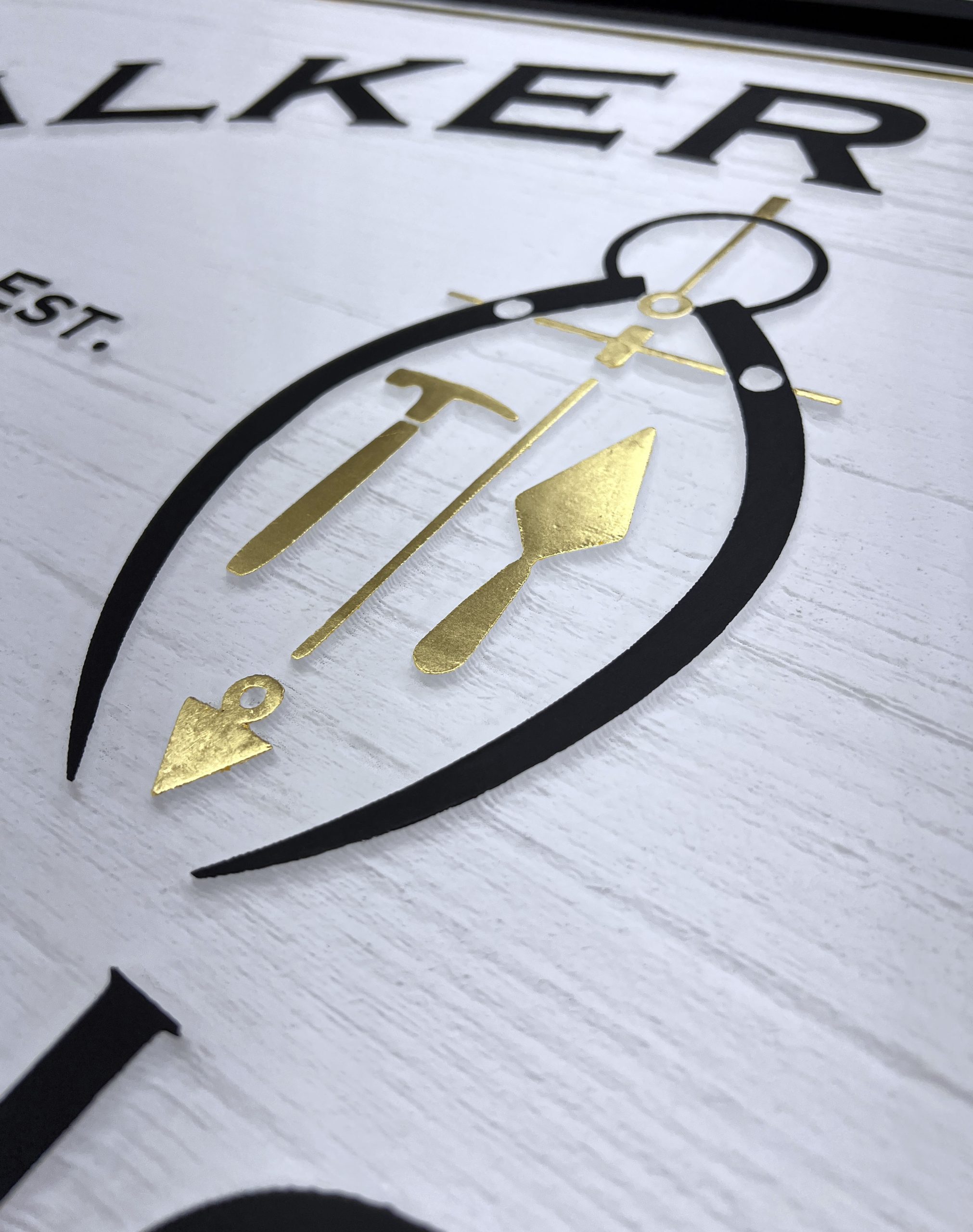 Gold leaf texture detail on sandblasted cedar showing the contrast between genuine gold and natural wood grain