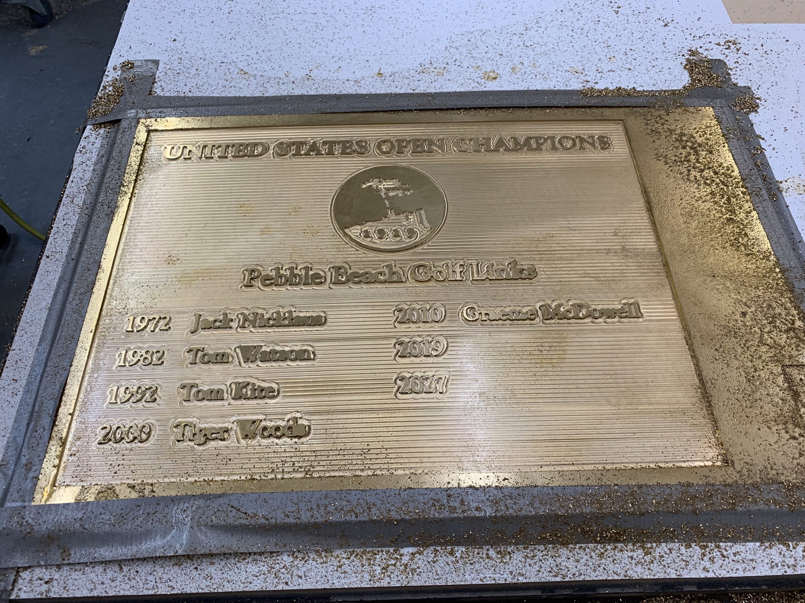 Pebble Beach Golf Links US Open Champions plaque being CNC-machined from marine brass on the Multicam router at Signworks