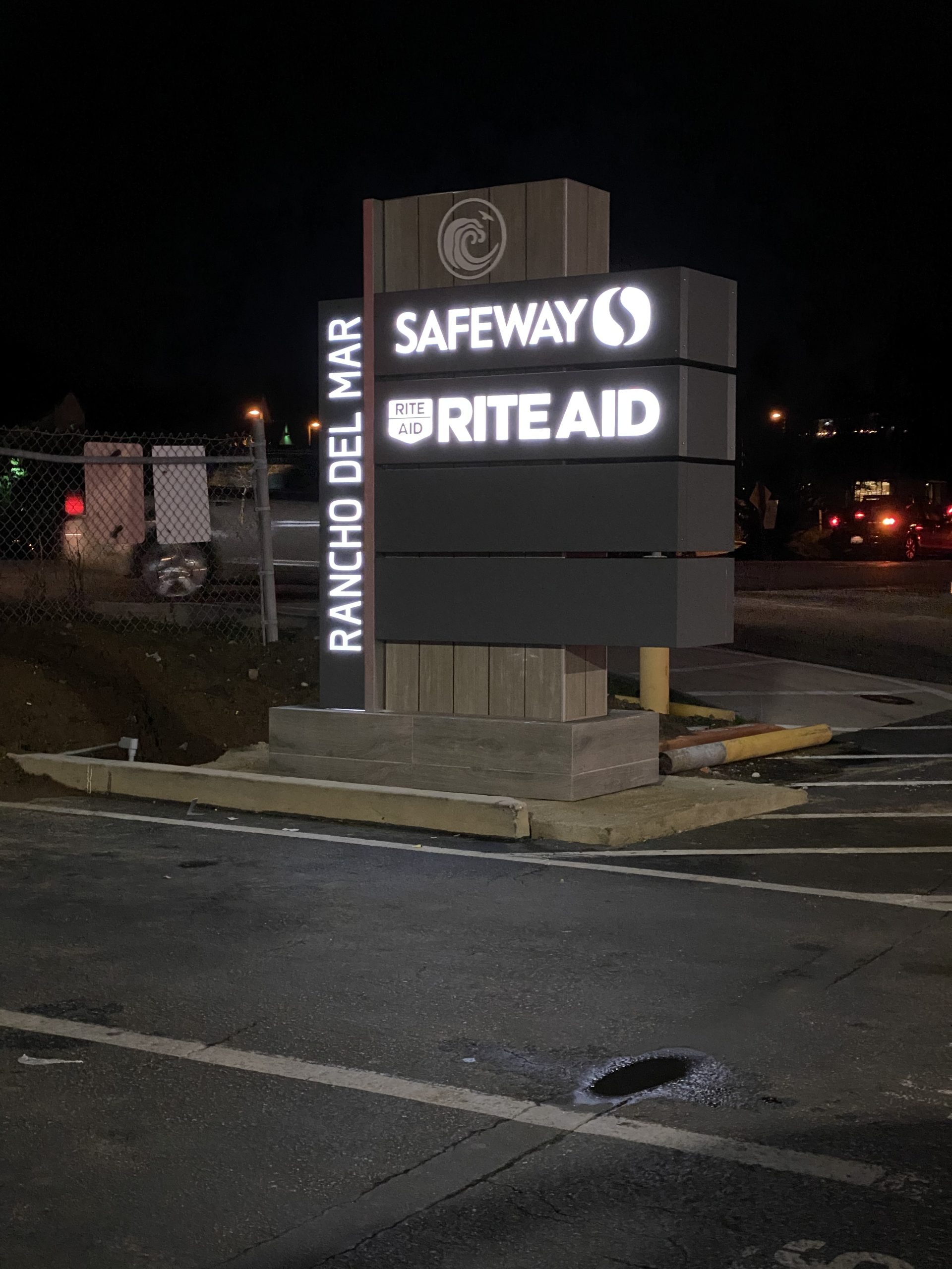 Rancho Del Mar illuminated monument sign at night showing Safeway and Rite Aid tenant panels