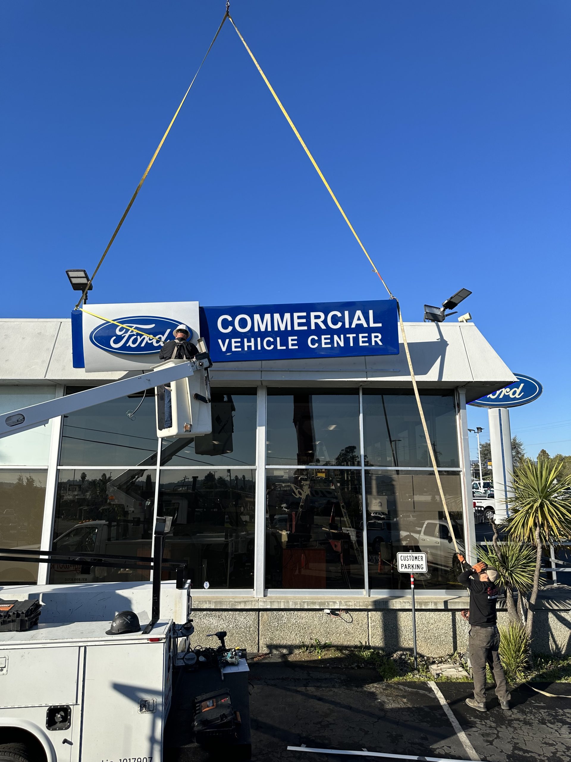 Ford Commercial Vehicle Center sign being installed by Signworks crew with crane in Watsonville