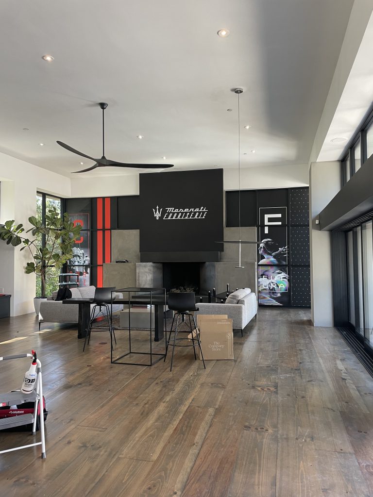 Maserati Fuoriserie interior branded lounge with wall graphics and dimensional signage at Monterey Car Week