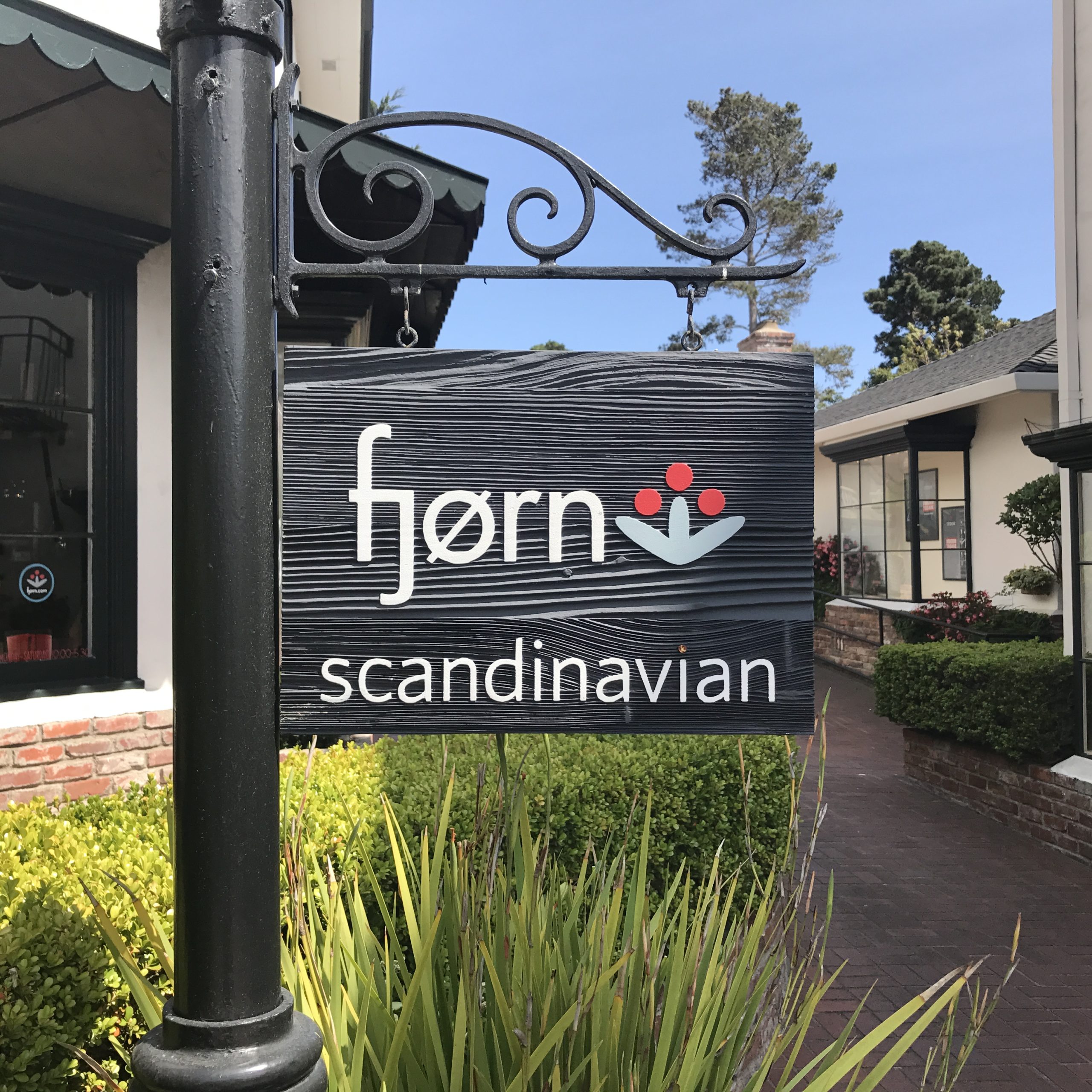 Fjorn Scandinavian hanging blade sign with wrought iron bracket installed by Signworks