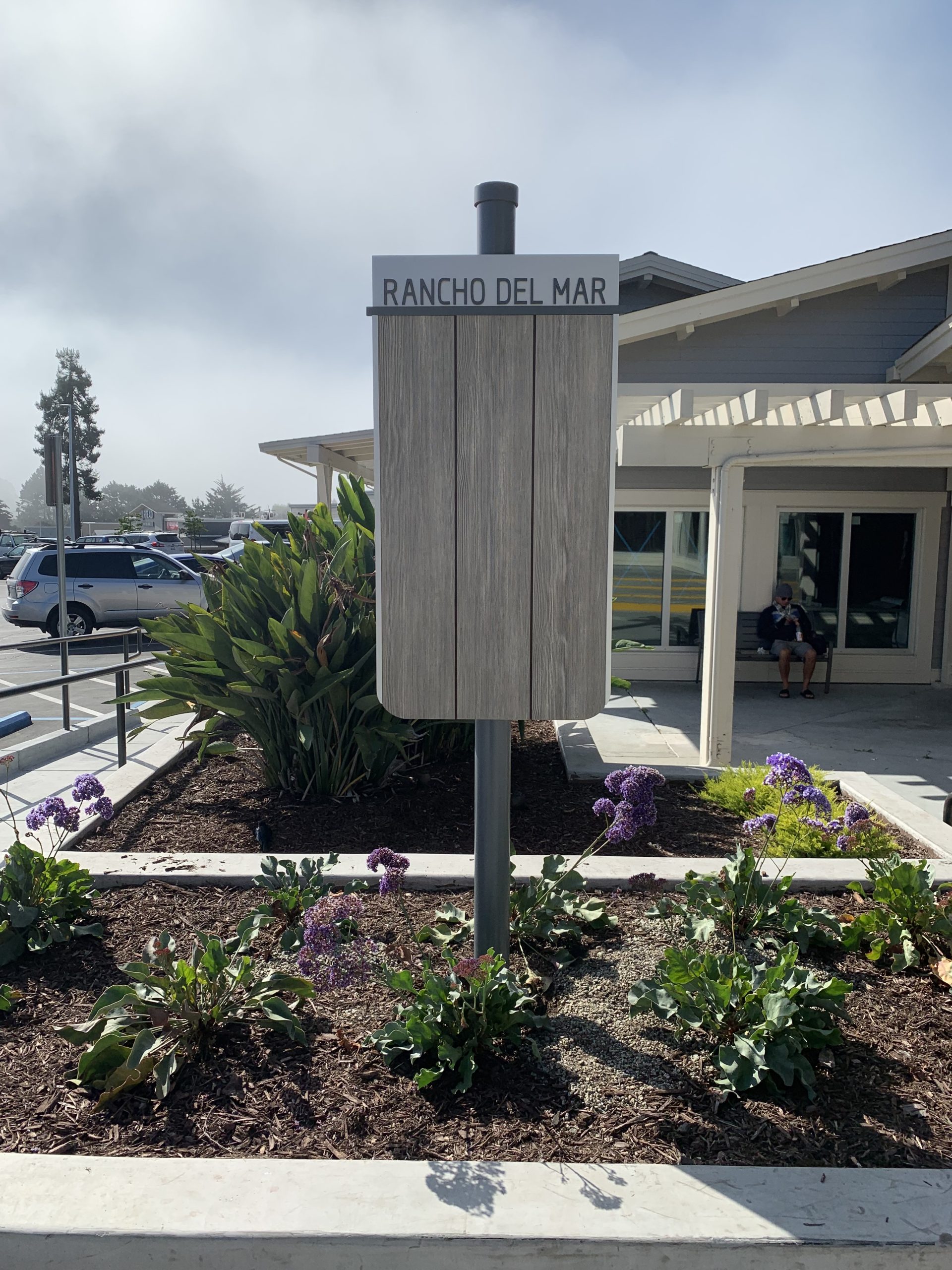 Rancho Del Mar wayfinding sign installed in landscaped area at shopping center
