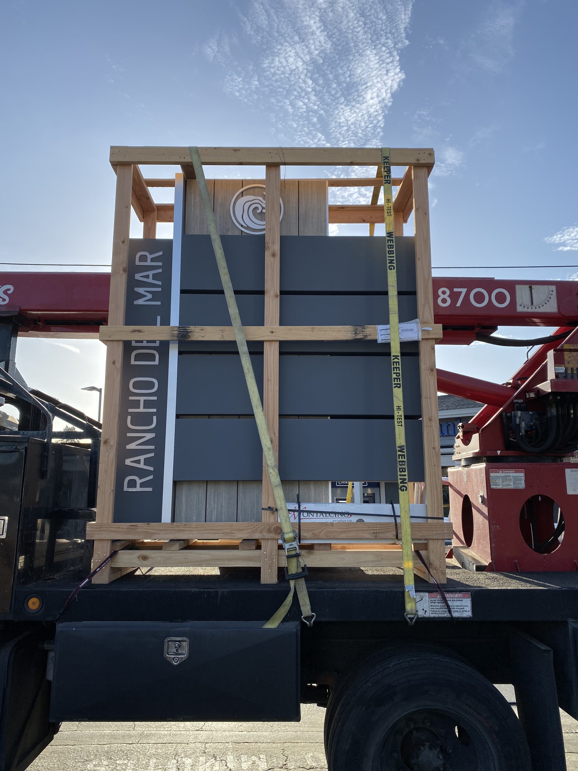 Rancho Del Mar shopping center monument sign crated and strapped on flatbed truck ready for delivery